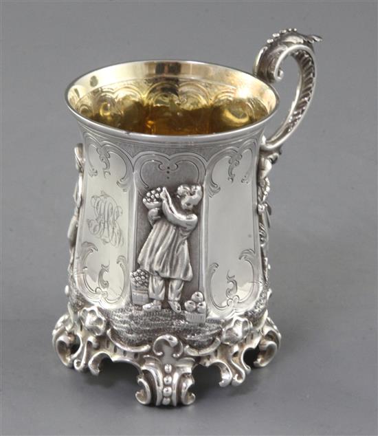 A cased Victorian ornate silver christening mug, 11cm.